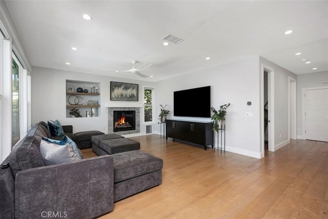 27705 Homestead Rd, Laguna Niguel, CA 92677 - living room featuring ceiling fan, light wood-style flooring, recessed lighting, a warm lit fireplace, and built in shelves