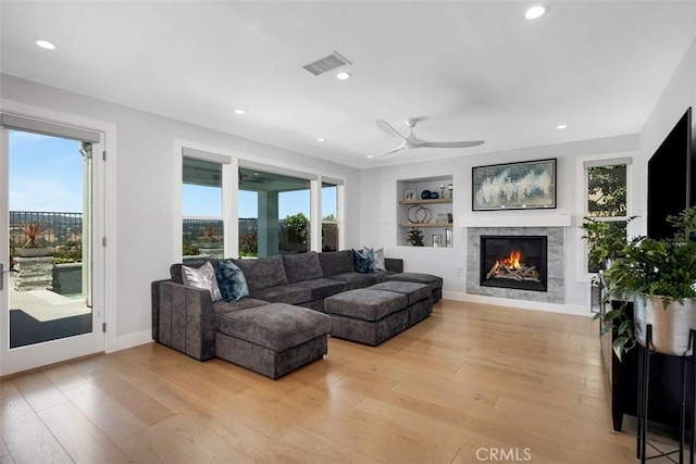 27705 Homestead Rd, Laguna Niguel, CA 92677 - living room featuring recessed lighting, a ceiling fan, a glass covered fireplace, light wood-style flooring, and built in shelves