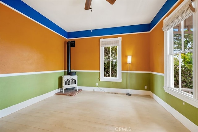 1780 Paso Robles St, Oceano, CA 93445 - spare room with a wood stove, a ceiling fan, and wood finished floors