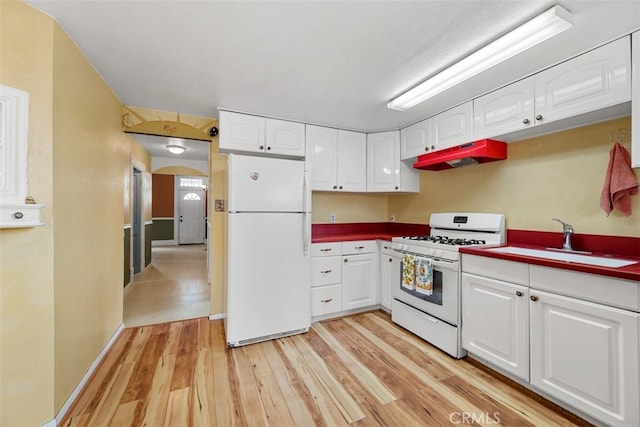 1780 Paso Robles St, Oceano, CA 93445 - kitchen featuring white appliances, under cabinet range hood, light wood finished floors, white cabinetry, and arched walkways