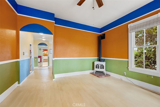 1780 Paso Robles St, Oceano, CA 93445 - unfurnished living room with ceiling fan, a wood stove, and wood finished floors