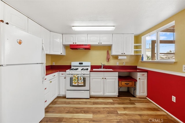 1780 Paso Robles St, Oceano, CA 93445 - kitchen with white appliances, under cabinet range hood, light wood finished floors, and white cabinetry