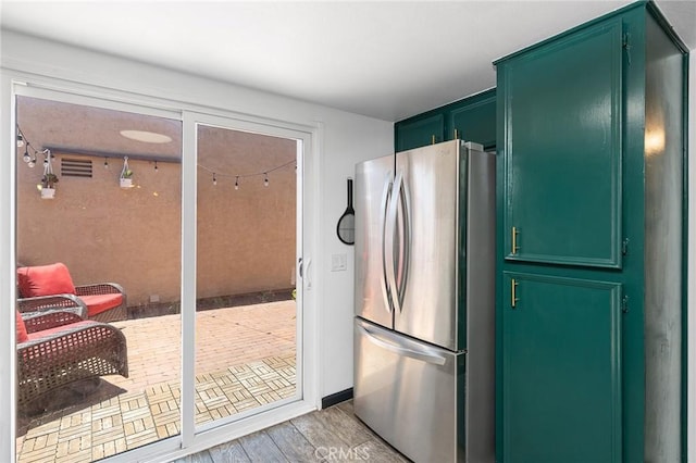 140 E El Norte Pkwy Unit 8, Escondido, CA 92026 - kitchen featuring freestanding refrigerator, green cabinets, and light wood-style flooring