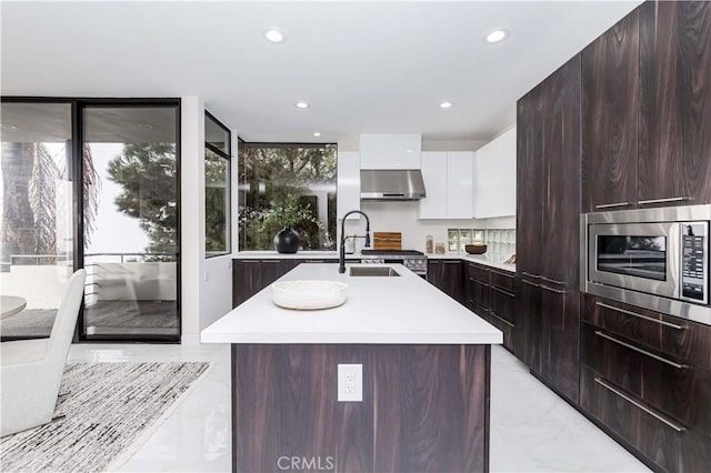 1195 La Mirada St, Laguna Beach, CA 92651 - kitchen with stainless steel microwave, modern cabinets, light marble finish floors, light countertops, and recessed lighting