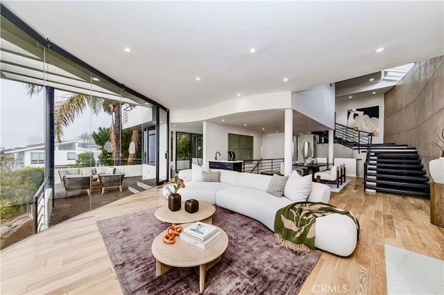 1195 La Mirada St, Laguna Beach, CA 92651 - living area with a wall of windows, stairway, wood finished floors, and recessed lighting