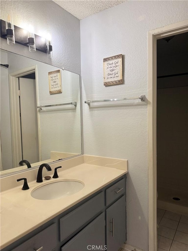 8711 Chessington Dr Unit D, Inglewood, CA 90305 - bathroom with vanity, tile patterned flooring, a textured ceiling, and a shower