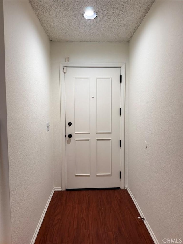 8711 Chessington Dr Unit D, Inglewood, CA 90305 - doorway featuring dark wood finished floors, a textured ceiling, recessed lighting, and a textured wall