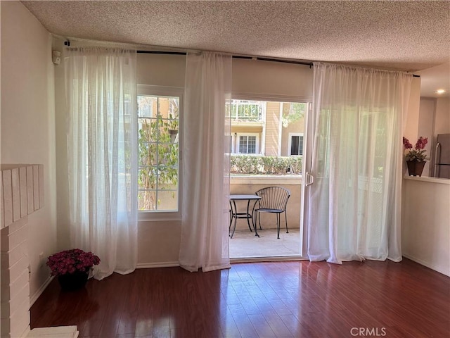 8711 Chessington Dr Unit D, Inglewood, CA 90305 - spare room with wood-type flooring, plenty of natural light, and a textured ceiling