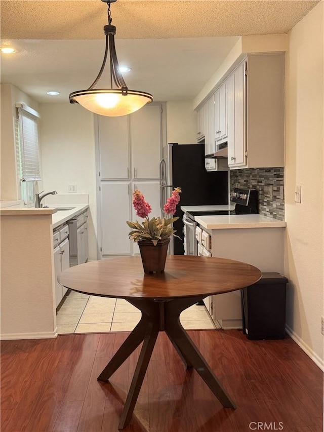 8711 Chessington Dr Unit D, Inglewood, CA 90305 - dining room featuring wood finished floors and a textured ceiling