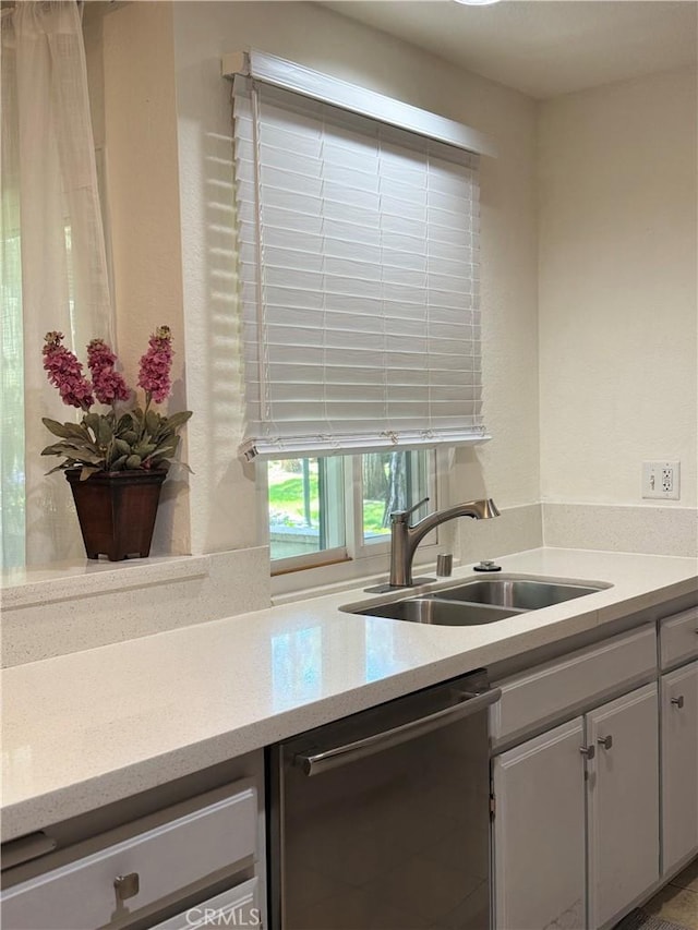 8711 Chessington Dr Unit D, Inglewood, CA 90305 - kitchen featuring stainless steel dishwasher, light countertops, and white cabinetry