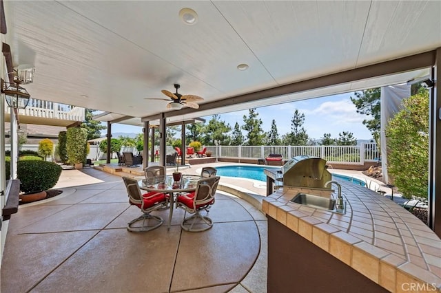 32409 Favara Dr, Temecula, CA 92592 - fenced backyard with a patio area, area for grilling, outdoor dining space, and a ceiling fan