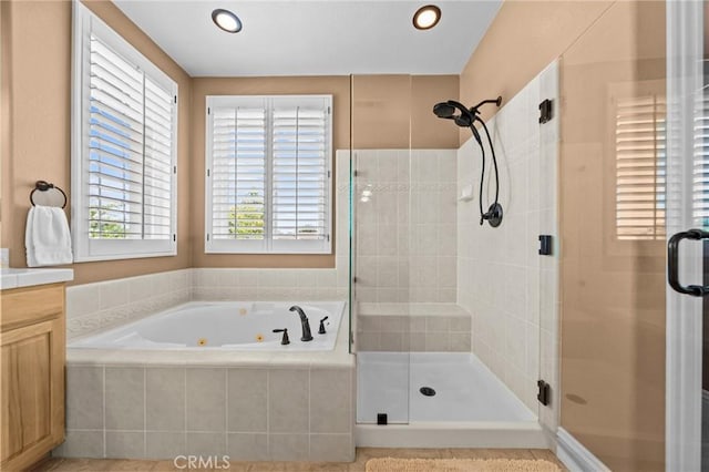 32409 Favara Dr, Temecula, CA 92592 - full bath with healthy amount of natural light, a shower stall, a whirlpool tub, vanity, and recessed lighting