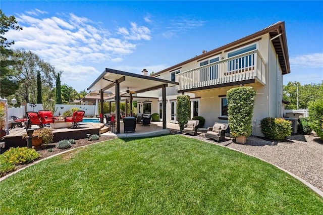 32409 Favara Dr, Temecula, CA 92592 - rear view of house with a balcony, an outdoor hangout area, a fenced backyard, and stucco siding
