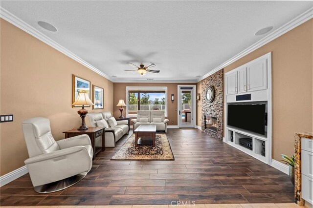 32409 Favara Dr, Temecula, CA 92592 - living room with crown molding, dark wood-style floors, a ceiling fan, and a fireplace