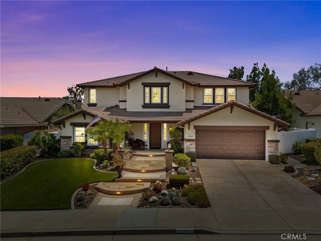32409 Favara Dr, Temecula, CA 92592 - view of front facade featuring covered porch, stone siding, a tile roof, concrete driveway, and stucco siding