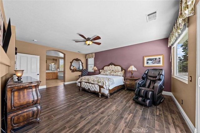 32409 Favara Dr, Temecula, CA 92592 - bedroom with arched walkways, wood finished floors, connected bathroom, and a ceiling fan