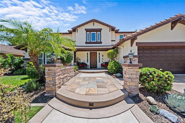 32409 Favara Dr, Temecula, CA 92592 - mediterranean / spanish home with stucco siding, a tile roof, a garage, and a porch