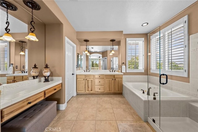 32409 Favara Dr, Temecula, CA 92592 - full bath featuring a bath, double vanity, healthy amount of natural light, and a stall shower