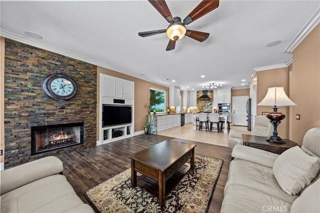 32409 Favara Dr, Temecula, CA 92592 - living area featuring ceiling fan, crown molding, a stone fireplace, light wood-style floors, and recessed lighting
