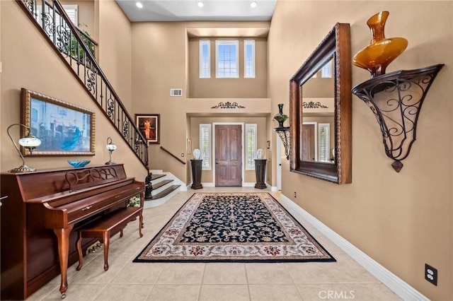 32409 Favara Dr, Temecula, CA 92592 - tiled foyer featuring stairs, a towering ceiling, and recessed lighting
