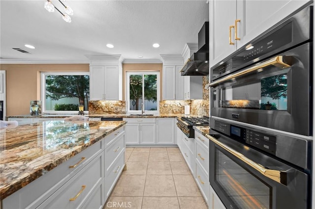 32409 Favara Dr, Temecula, CA 92592 - kitchen with gas cooktop, wall chimney range hood, crown molding, decorative backsplash, and white cabinetry
