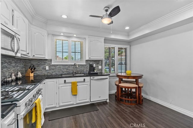 10622 Ashworth St, Bellflower, CA 90706 - kitchen featuring white appliances, dark countertops, tasteful backsplash, dark wood finished floors, and a ceiling fan
