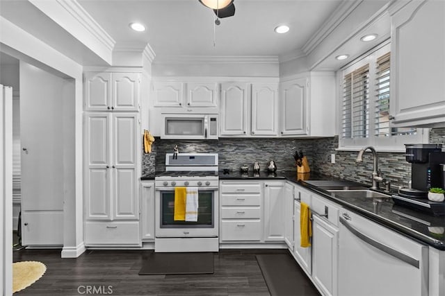 10622 Ashworth St, Bellflower, CA 90706 - kitchen featuring white appliances, dark countertops, white cabinets, ornamental molding, and dark wood-style flooring