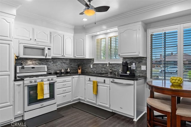 10622 Ashworth St, Bellflower, CA 90706 - kitchen featuring white appliances, a ceiling fan, dark countertops, dark wood-style floors, and white cabinetry