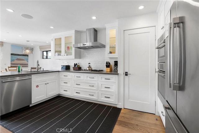 112 30th St, Newport Beach, CA 92663 - kitchen with appliances with stainless steel finishes, wall chimney range hood, white cabinetry, dark wood-type flooring, and dark countertops