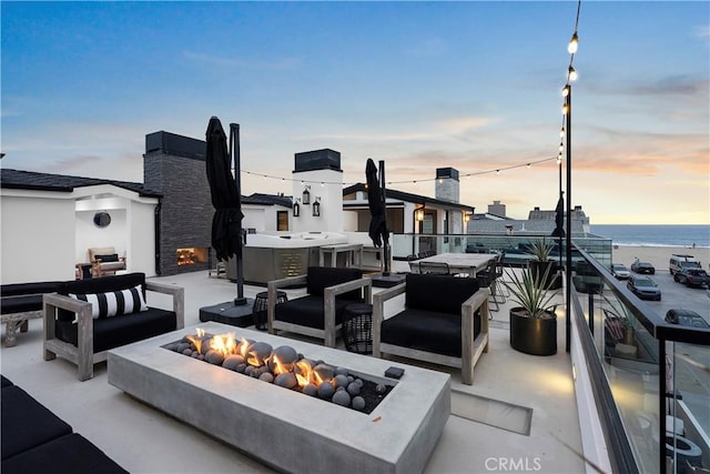 112 30th St, Newport Beach, CA 92663 - view of patio / terrace with an outdoor living space with a fireplace and a water view