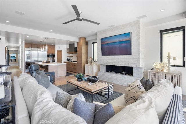 112 30th St, Newport Beach, CA 92663 - living room with a ceiling fan, light wood-style flooring, a brick fireplace, and recessed lighting