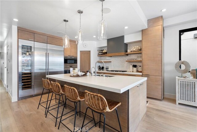 112 30th St, Newport Beach, CA 92663 - kitchen featuring stainless steel appliances, open shelves, modern cabinets, light countertops, and wall chimney exhaust hood