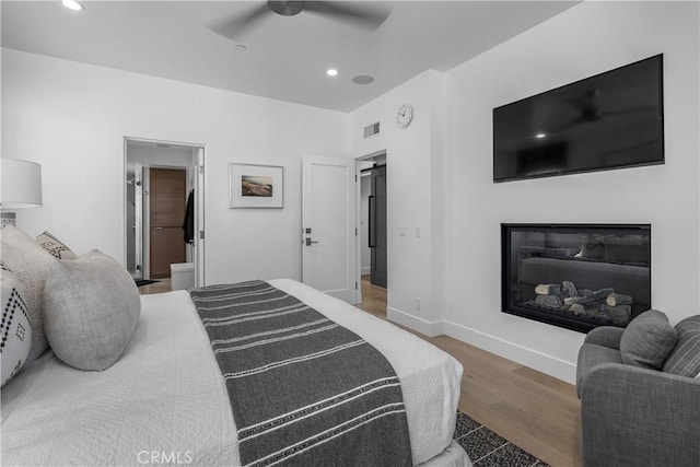 112 30th St, Newport Beach, CA 92663 - bedroom featuring wood finished floors, recessed lighting, ceiling fan, and a glass covered fireplace