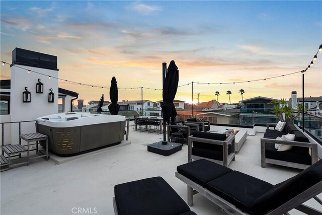 112 30th St, Newport Beach, CA 92663 - patio terrace at dusk with a hot tub, an outdoor living space, and a patio area