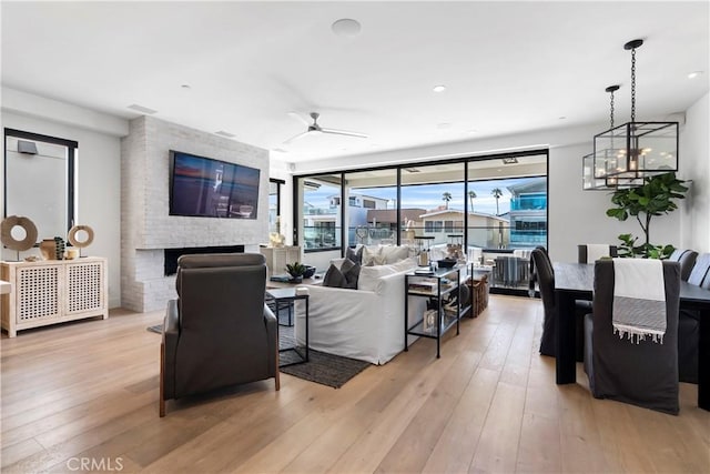 112 30th St, Newport Beach, CA 92663 - living area featuring light wood finished floors, a fireplace, and a ceiling fan