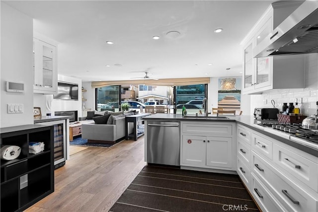 112 30th St, Newport Beach, CA 92663 - kitchen with appliances with stainless steel finishes, wall chimney exhaust hood, a peninsula, white cabinets, and glass insert cabinets