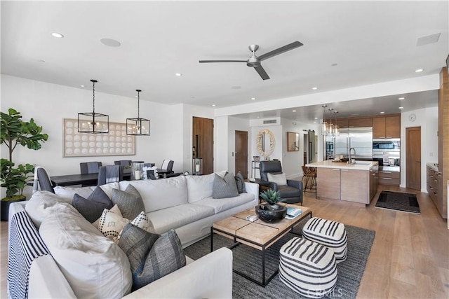 112 30th St, Newport Beach, CA 92663 - living room featuring light wood-style floors, ceiling fan, a chandelier, and recessed lighting