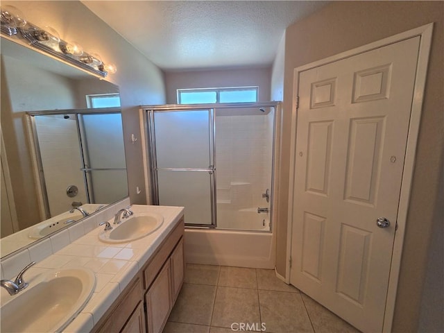 1315 Navello, El Cajon, CA 92021 - bathroom featuring double vanity, combined bath / shower with glass door, tile patterned flooring, and a textured ceiling