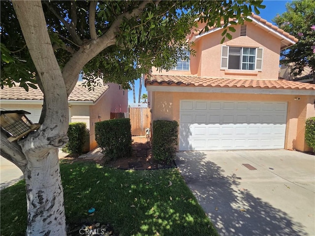1315 Navello, El Cajon, CA 92021 - view of front of home with driveway, an attached garage, a tiled roof, and stucco siding