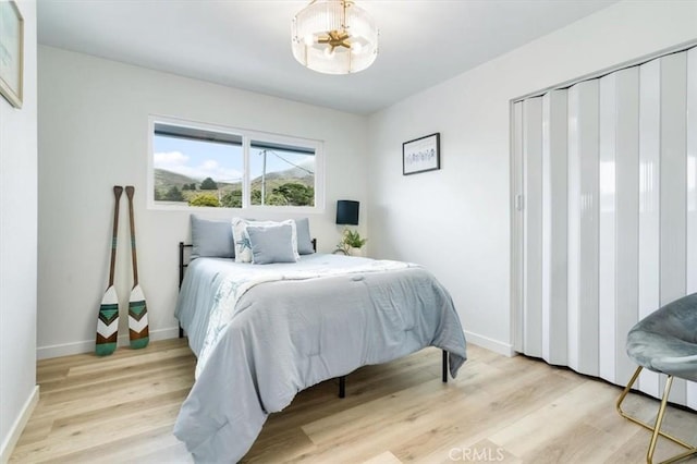 31 N 3rd St, Cayucos, CA 93430 - bedroom with a chandelier and light wood-style flooring