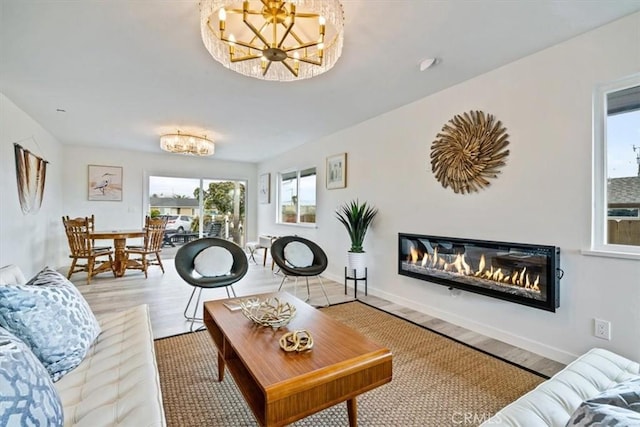 31 N 3rd St, Cayucos, CA 93430 - living area with a chandelier, wood finished floors, and a glass covered fireplace