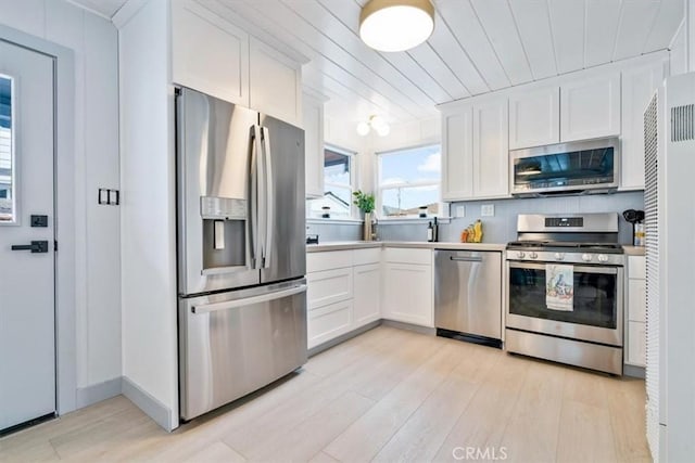 31 N 3rd St, Cayucos, CA 93430 - kitchen featuring stainless steel appliances, light wood-style floors, white cabinets, and light countertops