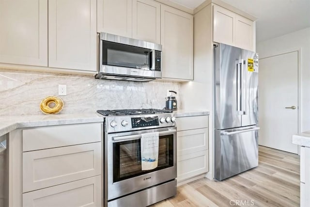 31 N 3rd St, Cayucos, CA 93430 - kitchen featuring appliances with stainless steel finishes, light wood-style floors, and tasteful backsplash