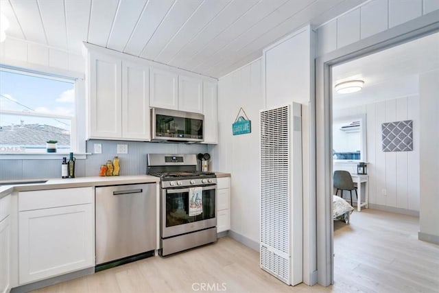 31 N 3rd St, Cayucos, CA 93430 - kitchen featuring stainless steel appliances, a heating unit, light wood-style floors, white cabinetry, and wood ceiling