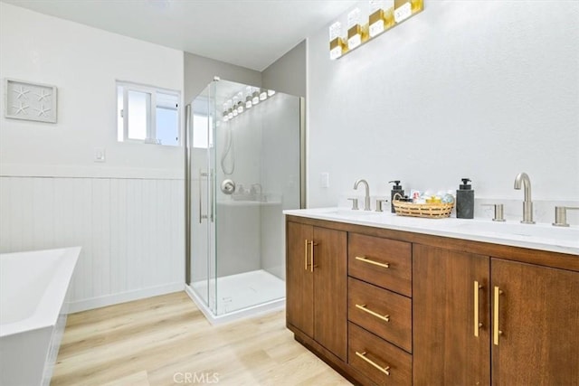 31 N 3rd St, Cayucos, CA 93430 - full bathroom with wood finished floors, a freestanding tub, a stall shower, wainscoting, and double vanity