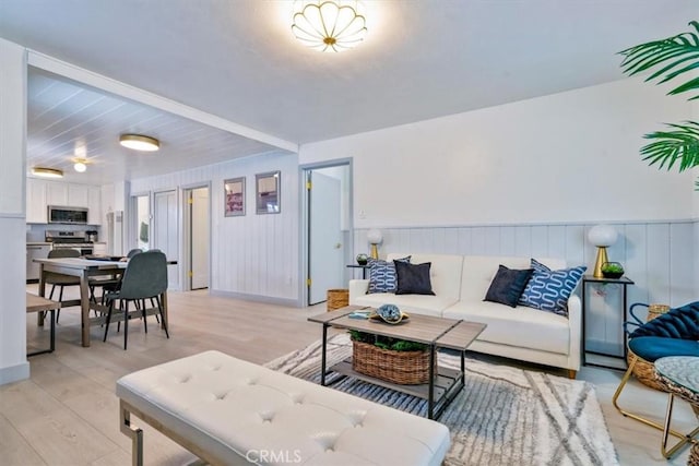 31 N 3rd St, Cayucos, CA 93430 - living room featuring light wood-style flooring and wainscoting