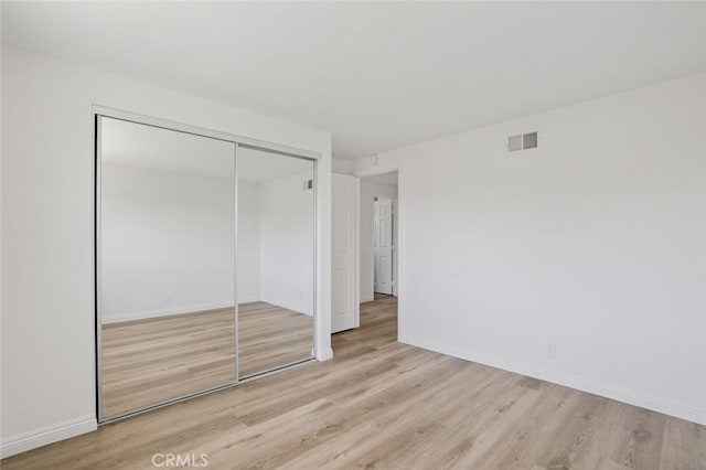 14652 Devonshire Ave, Tustin, CA 92780 - unfurnished bedroom with wood finished floors and a closet