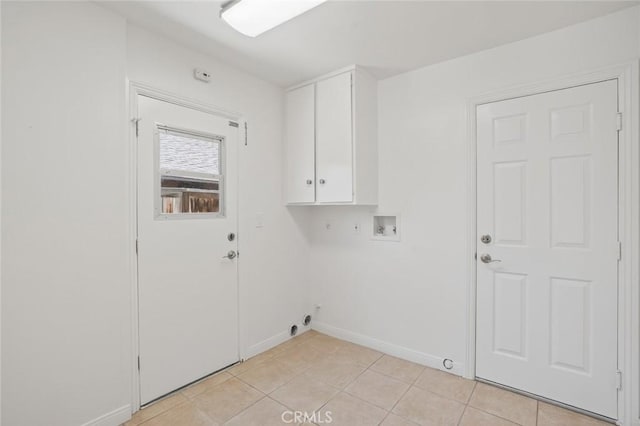 14652 Devonshire Ave, Tustin, CA 92780 - washroom with cabinet space, hookup for a washing machine, light tile patterned flooring, and hookup for a gas dryer