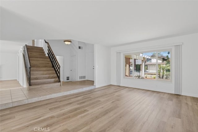 14652 Devonshire Ave, Tustin, CA 92780 - unfurnished living room with wood finished floors and stairway
