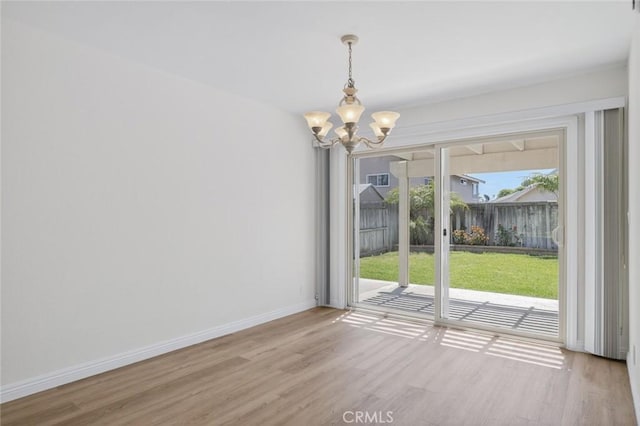 14652 Devonshire Ave, Tustin, CA 92780 - unfurnished dining area featuring a chandelier and light wood-type flooring